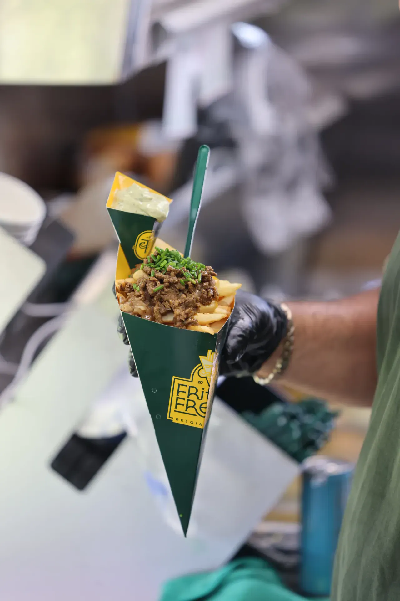 A signature cone of Belgian fries loaded with steak, chives and herb aioli